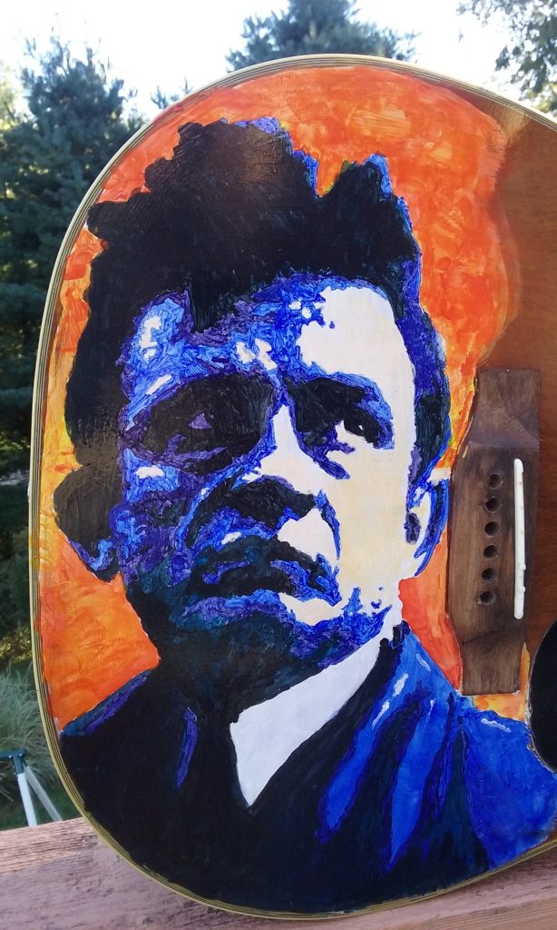 This acoustic guitar has been painted with Johnny Cash.